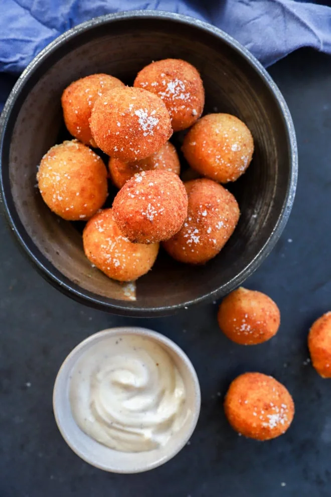 Bowl of cheese croquettes with dipping sauce