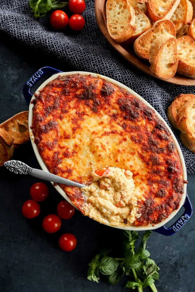 spoon in baking dish with four cheese baked mixture