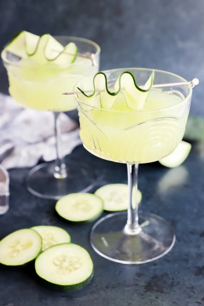 refreshing summer cocktail in coupe glasses with fresh vegetables