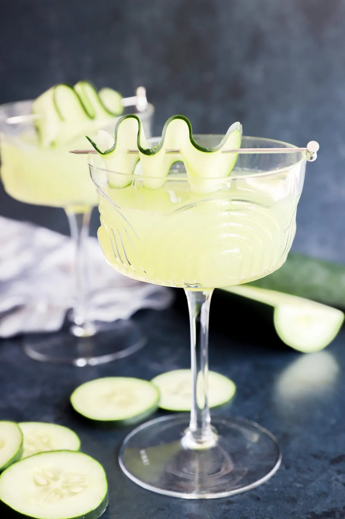 Summery produce cocktail in glasses with fresh garnish