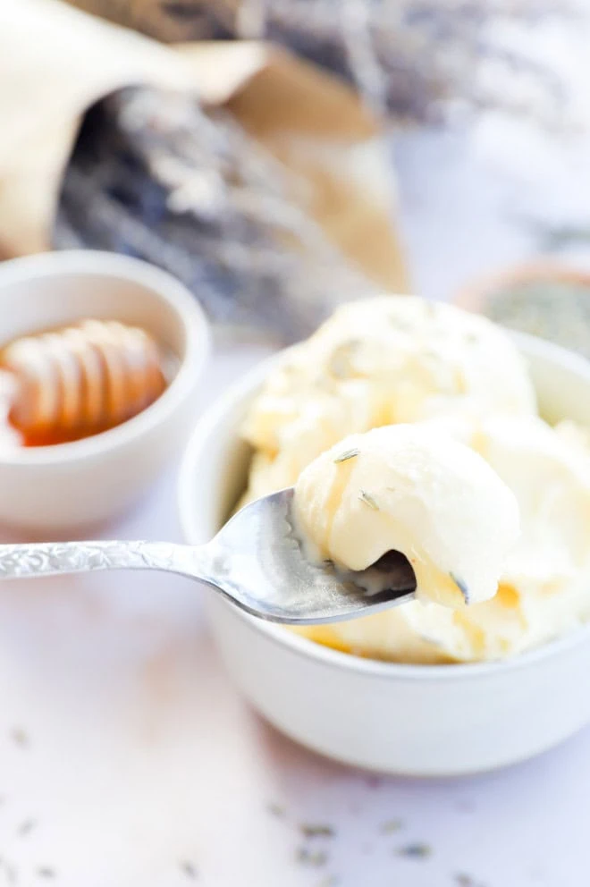 spoon scooping out frozen dessert from a bowl with flowers