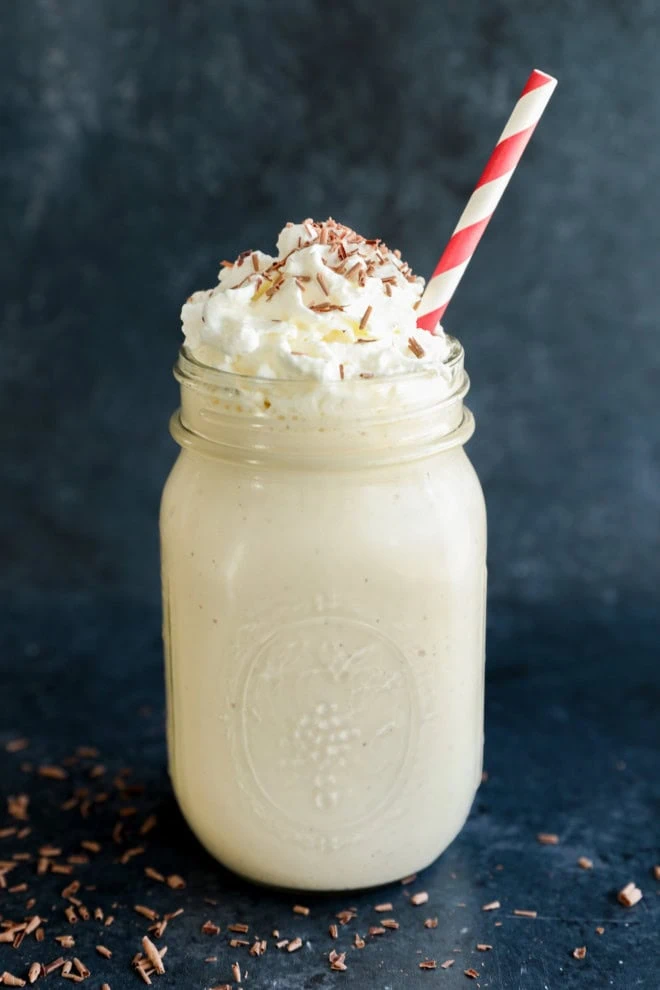 baileys coffee milkshake in mason jar with whipped cream and chocolate shavings