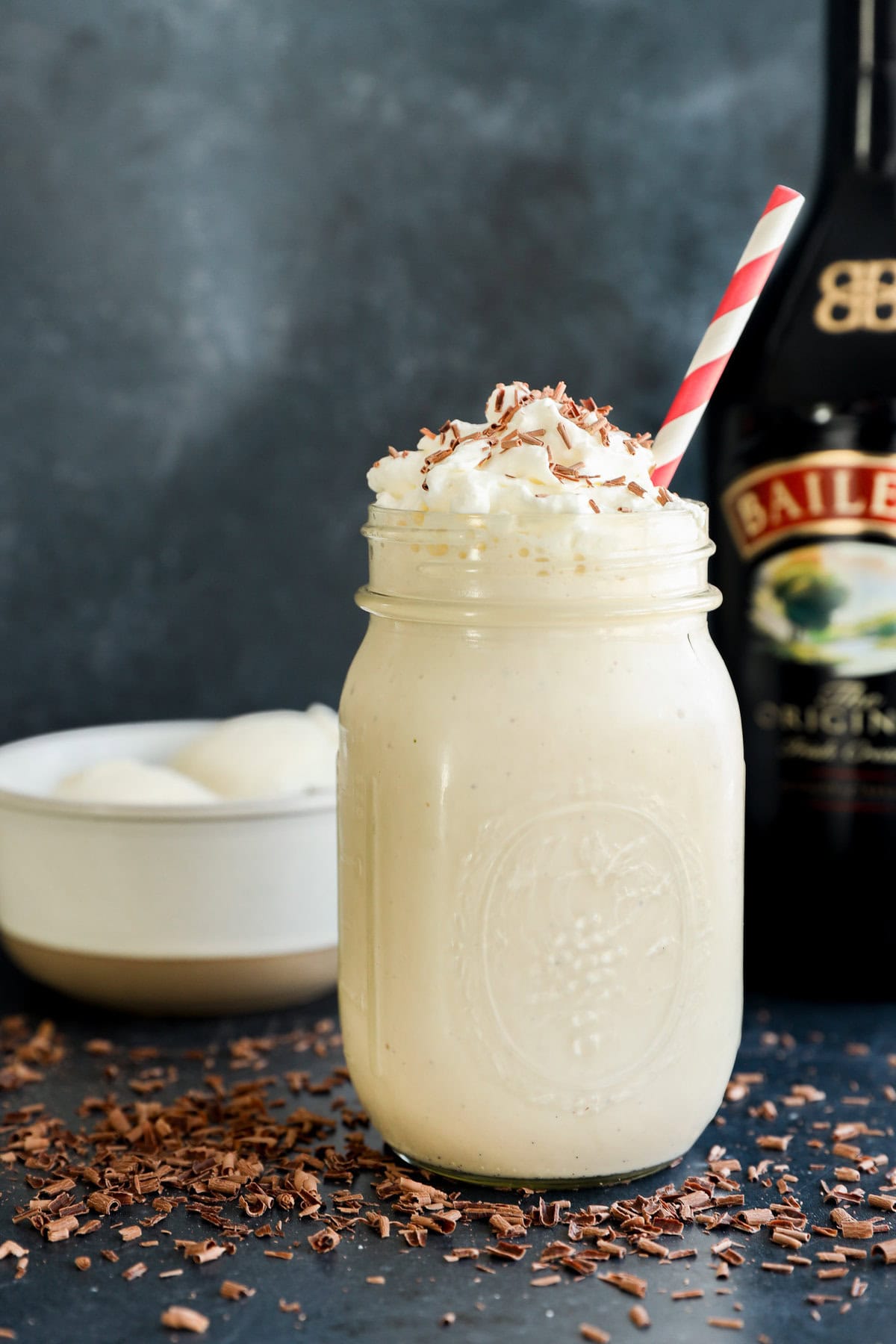 easy creamy boozy irish whiskey irish cream drink with whipped cream on top and straw