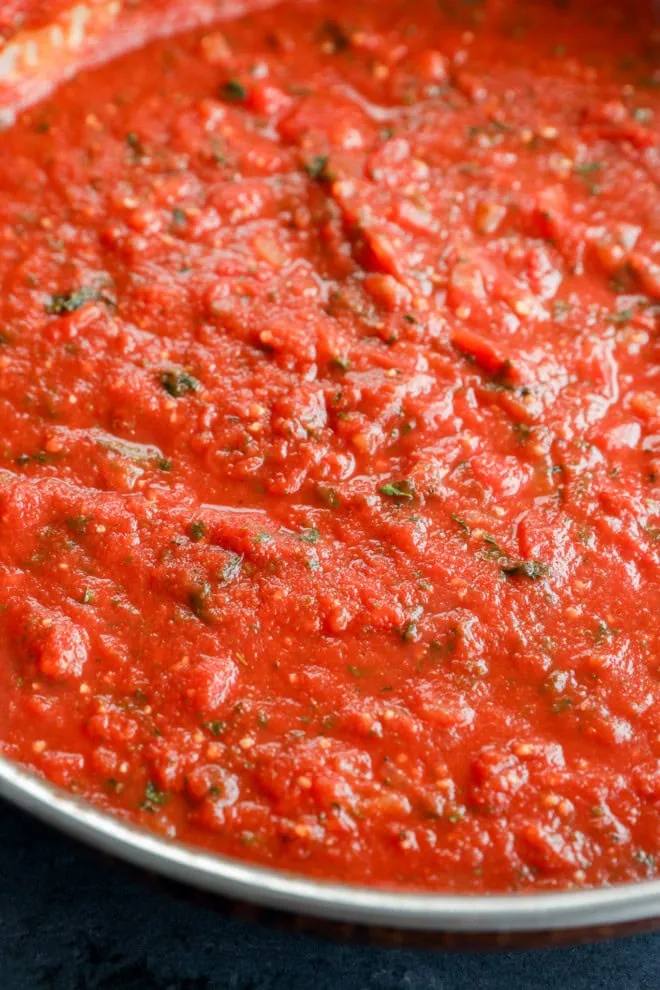 simmering homemade tomato sauce in a stainless steel skillet