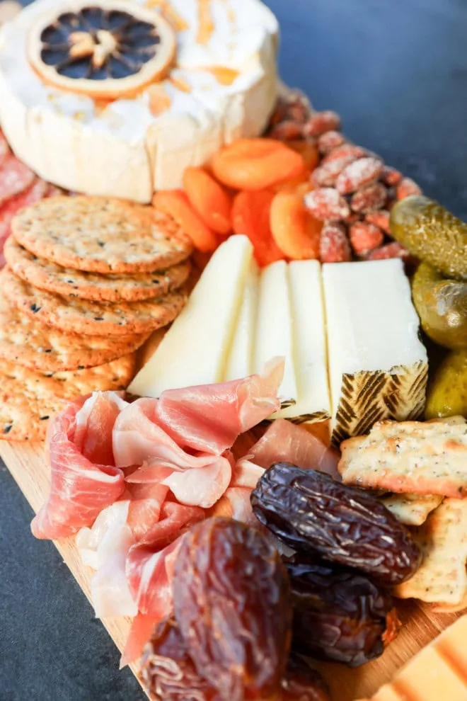 easy charcuterie board with meats, cheeses, dried fruits, and pickles