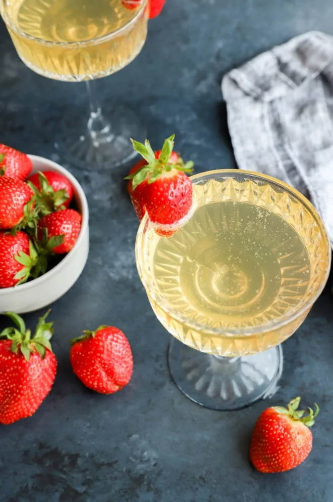 sparkling wine cocktail with fresh berries in glasses