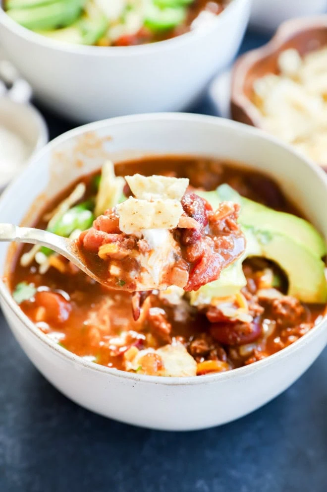 Spoons with taco chili on them with your favorite toppings