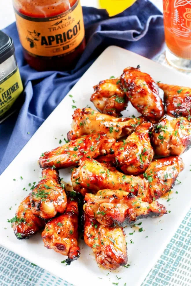 easy grilled beer marinated wings recipe on platter with fresh herbs