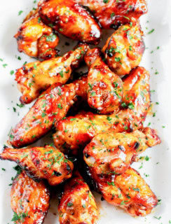 platter of grilled beer marinated wings with fresh herbs