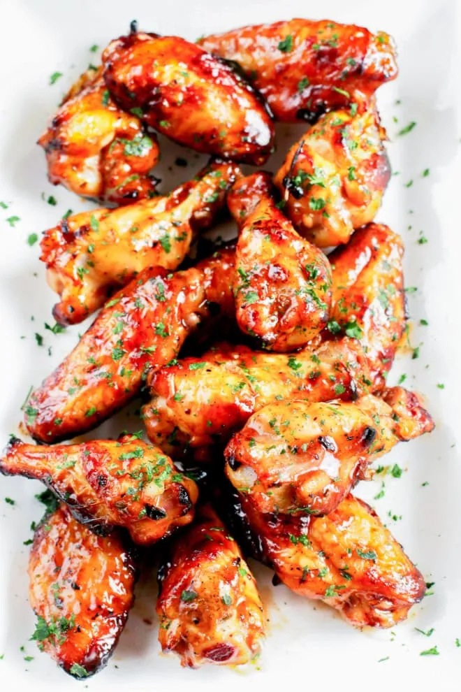 platter of grilled beer marinated wings with fresh herbs