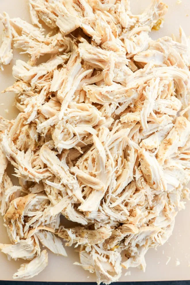 shredded chicken on a cutting board