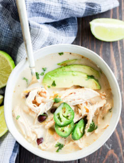 Bowl of Slow cooker creamy white chicken chili with spoon in it