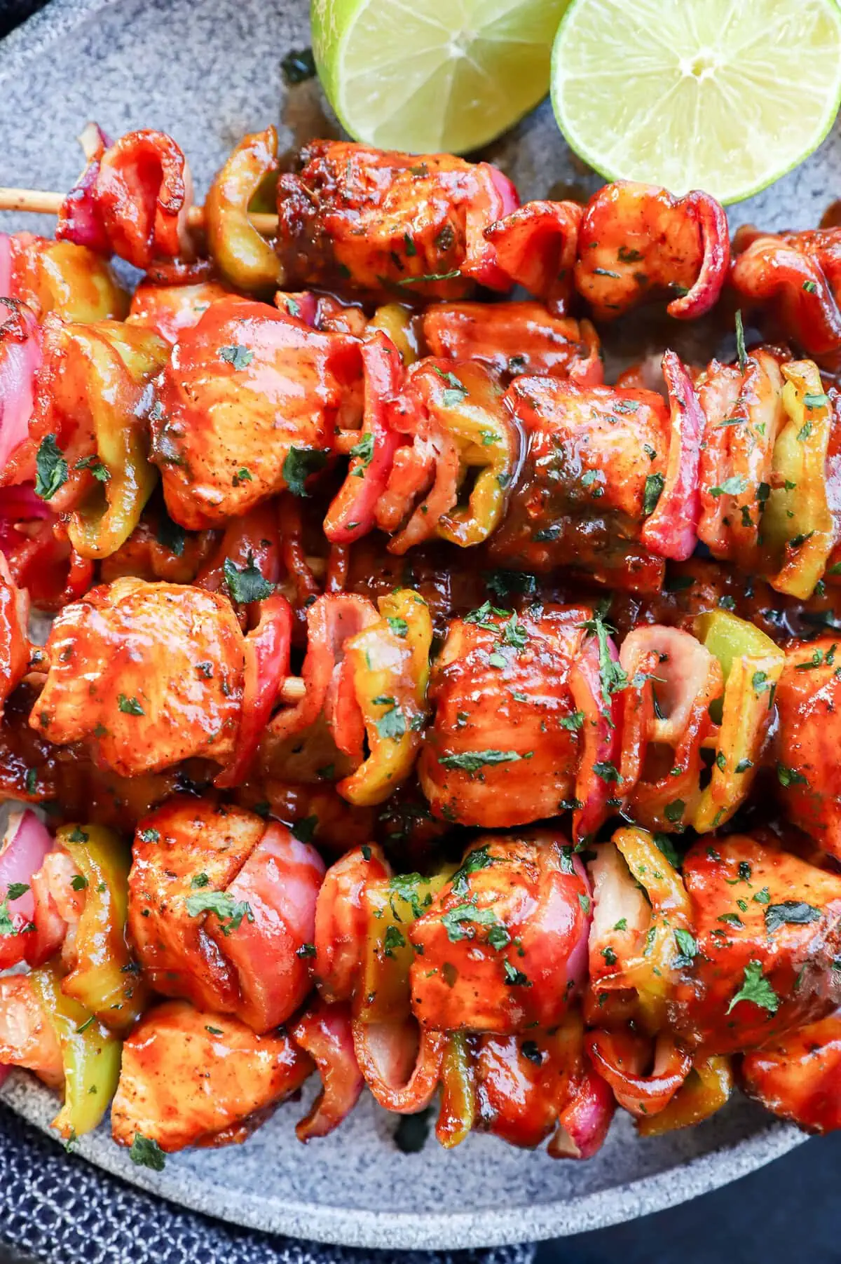 Skewers of chicken, bacon, onion, and bell pepper with bbq sauce