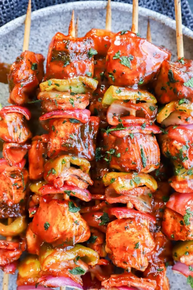 Kabobs made with chicken, bacon, onion, and bell pepper with bbq sauce