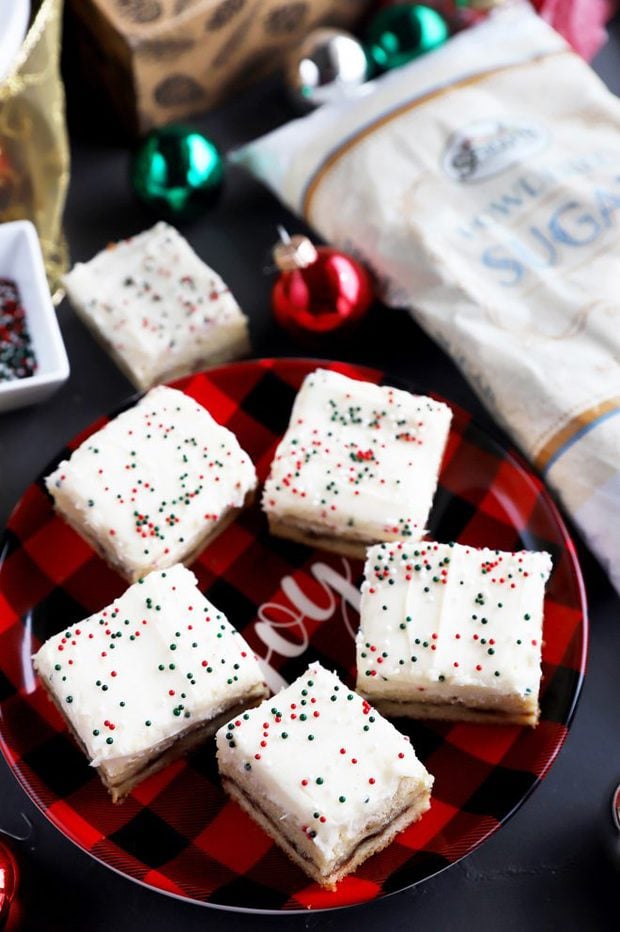 Chewy cookie bars with frosting on a plate