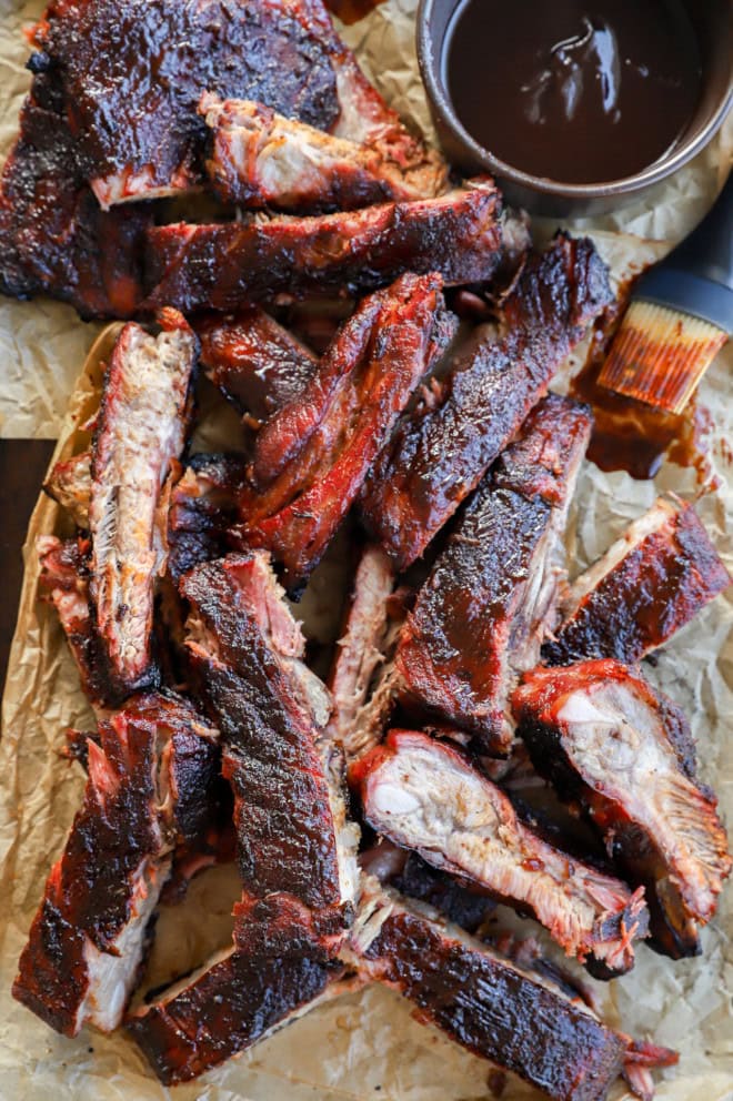 sliced pork BBQ on parchment paper on baking sheet