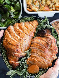 holding a plate of sliced meat for the Thanksgiving table