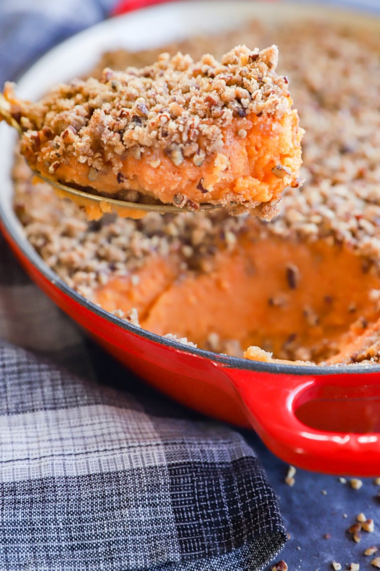 sweet potato souffle in baking pan with spoon