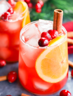 Glasses full of christmas punch with cinnamon sticks in them