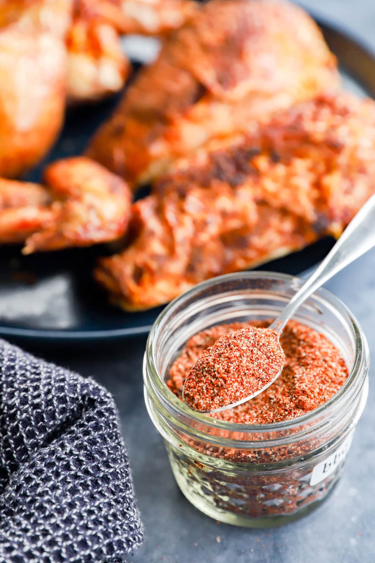 Grilled poultry on a plate with dry seasoning