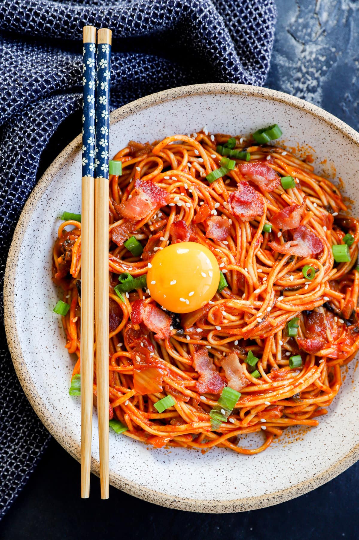 Kimchi udon in a bowl with egg yolk on top