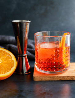 Aperol negroni in a cocktail glass with jigger