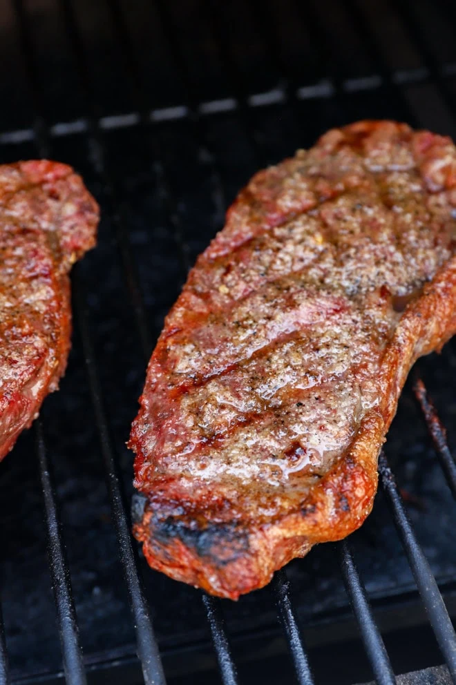 Grilling steaks on the grill