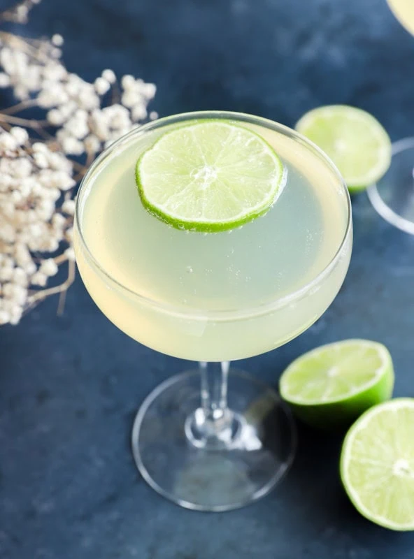 easy champagne drink in coupe glass with limes