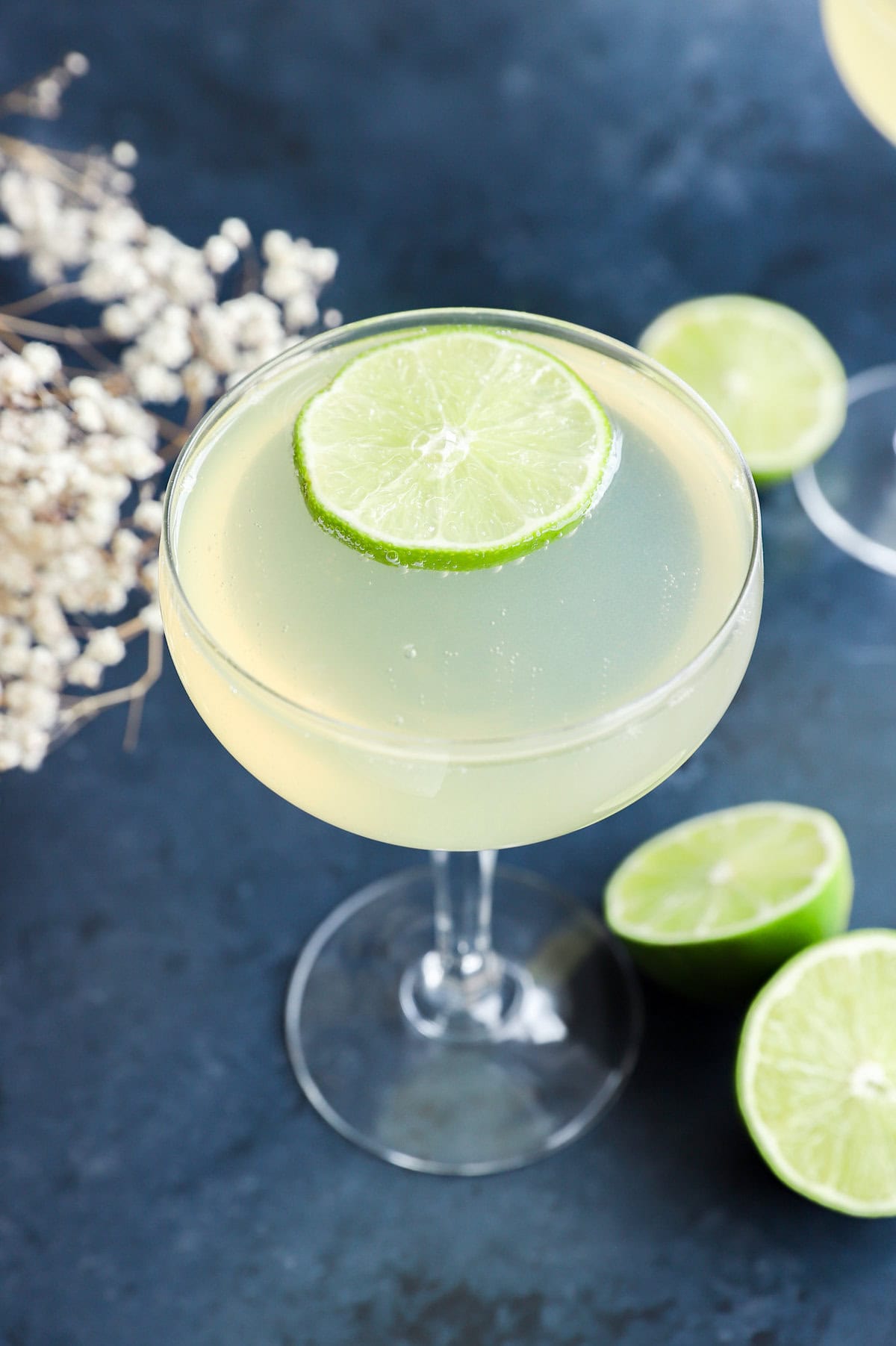 easy champagne drink in coupe glass with limes