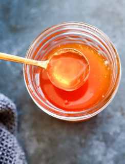 spoon of hot honey from jar