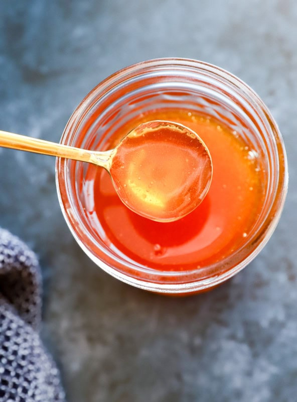 spoon of hot honey from jar