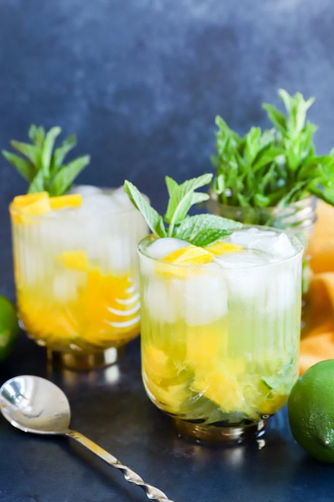 fruity cocktail with mint sprigs and lime