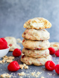 stack of baked fruity treats with fresh raspberries