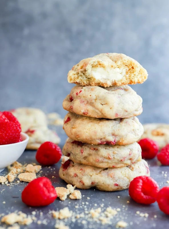 stack of baked fruity treats with fresh raspberries