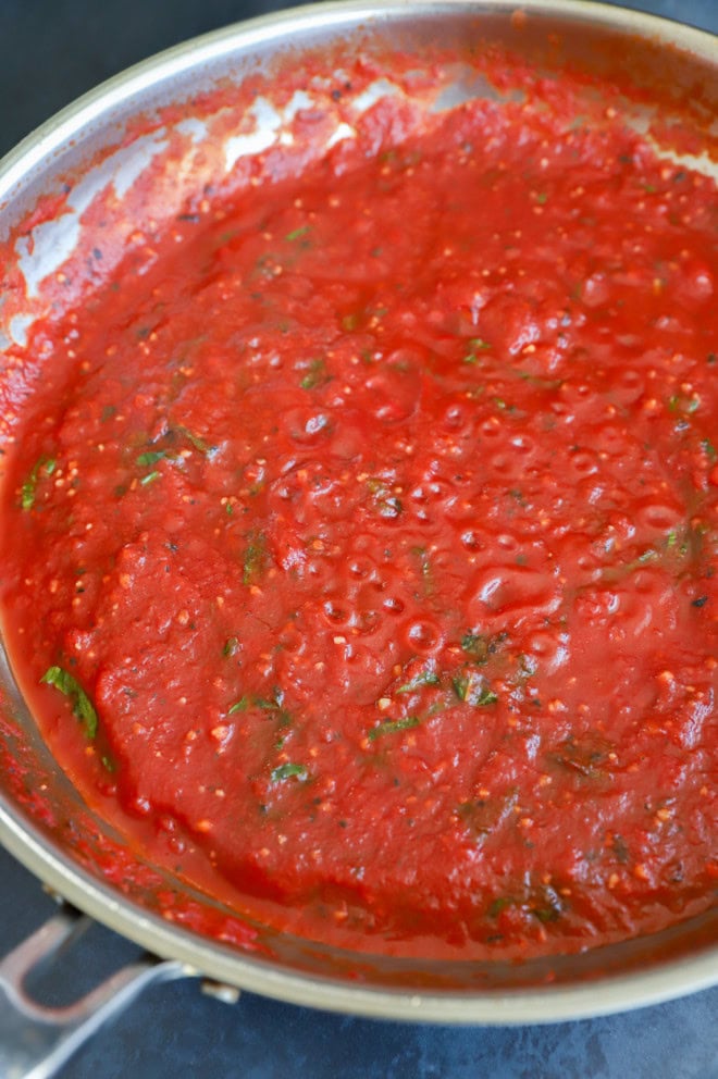 pomodoro sauce in a skillet with fresh basil