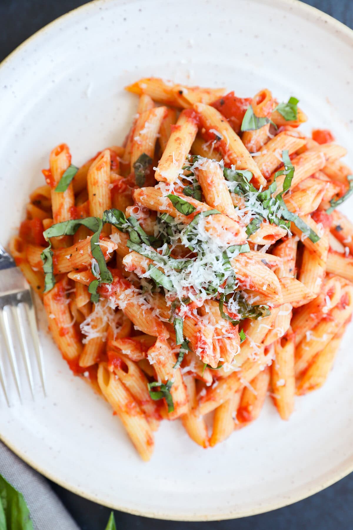 Tomato pasta on plate with fork