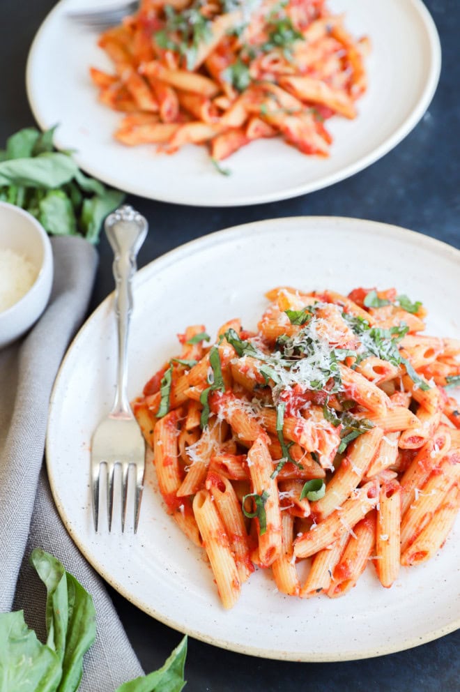 Easy Italian pasta dish on plate with fresh basil and cheese