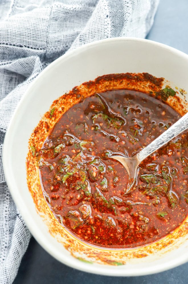 Bowl of mexican chicken marinade with linen underneath