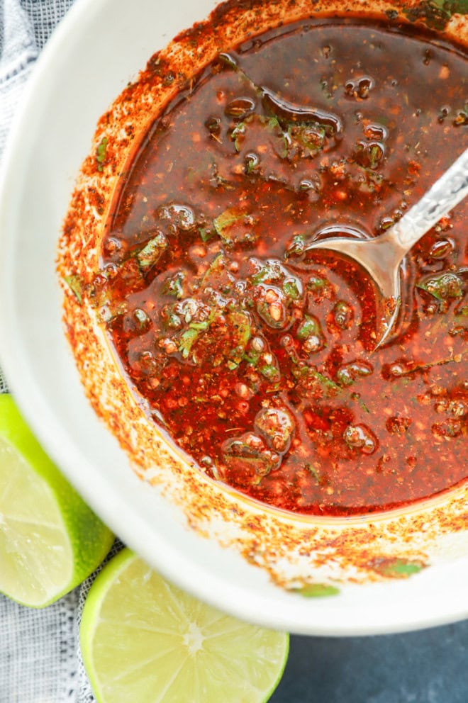 Mexican chicken marinade in a bowl with a pretty spoon