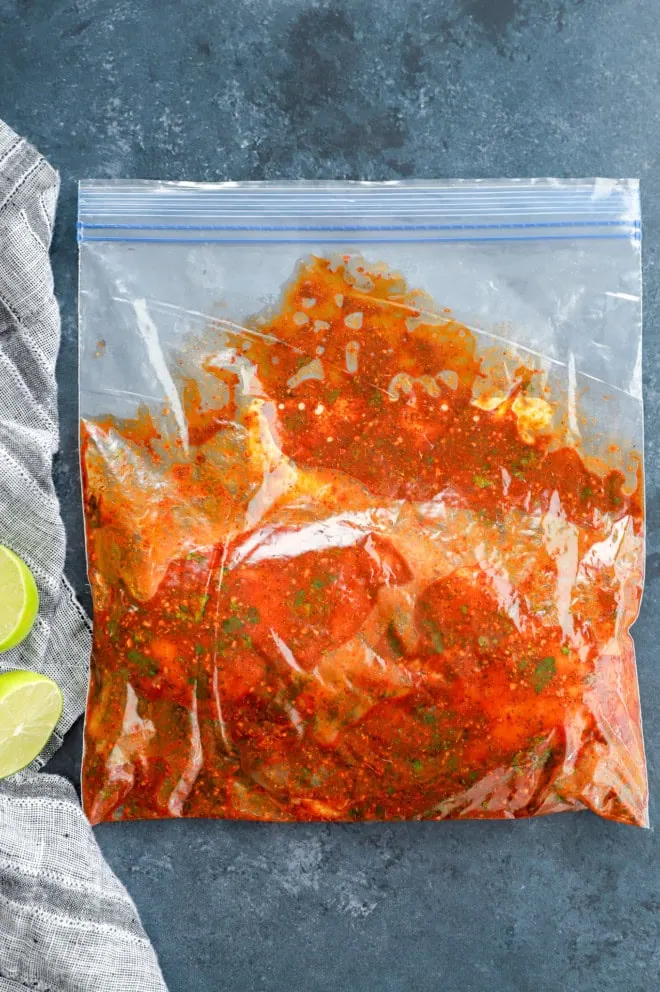 bag with chicken in it to marinate with linen and fresh limes