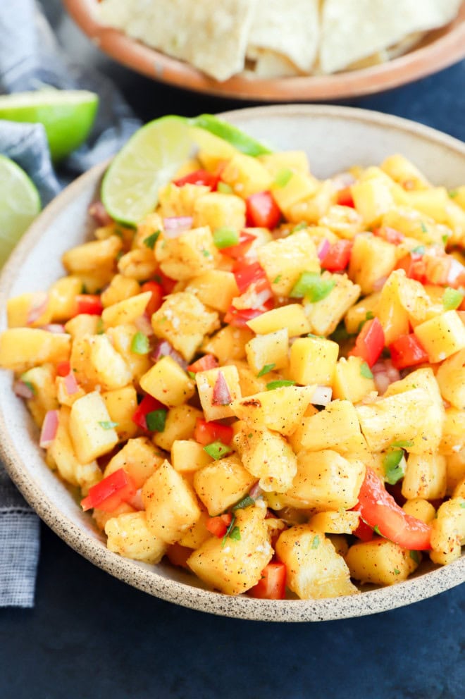 bowl of a fruity tropical appetizer with chips on the side