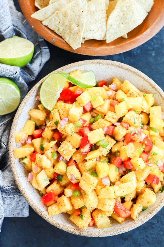 Bowl of fruity appetizer with fresh limes and chips