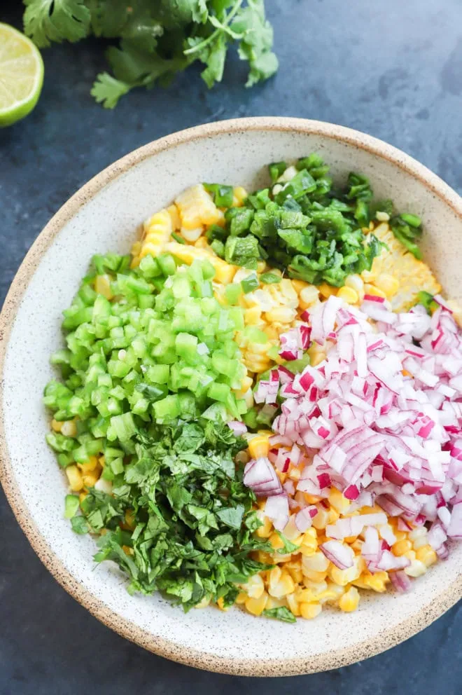 roasted chili corn salsa in a bowl before stirring it all together