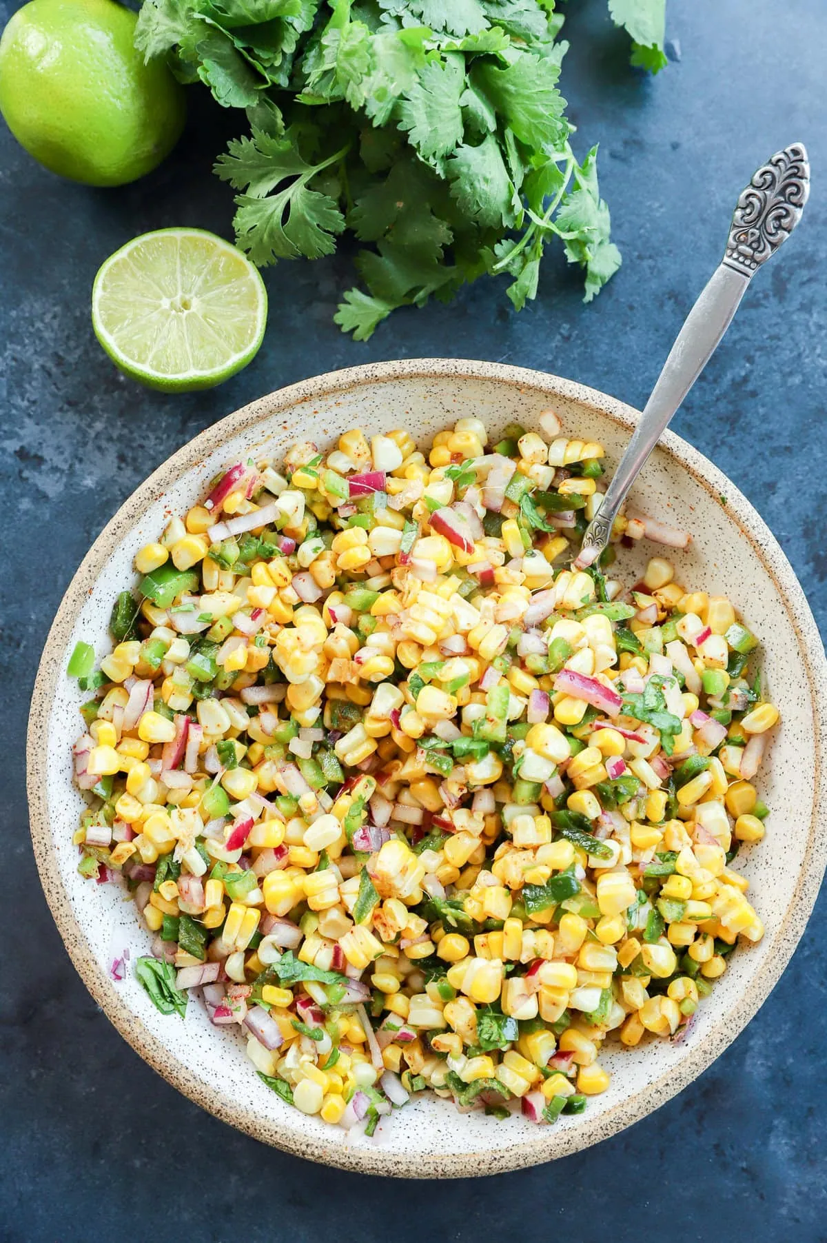 fresh vegetable appetizer in a bowl with cilantro and lime