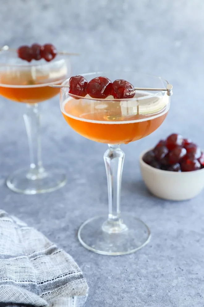 San Francisco cocktail in coupe glasses with brandied cherries