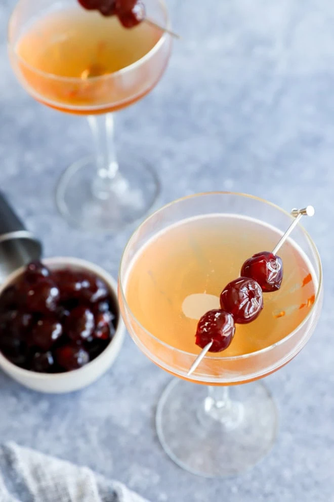 Classic drink in coupe glasses with cherries