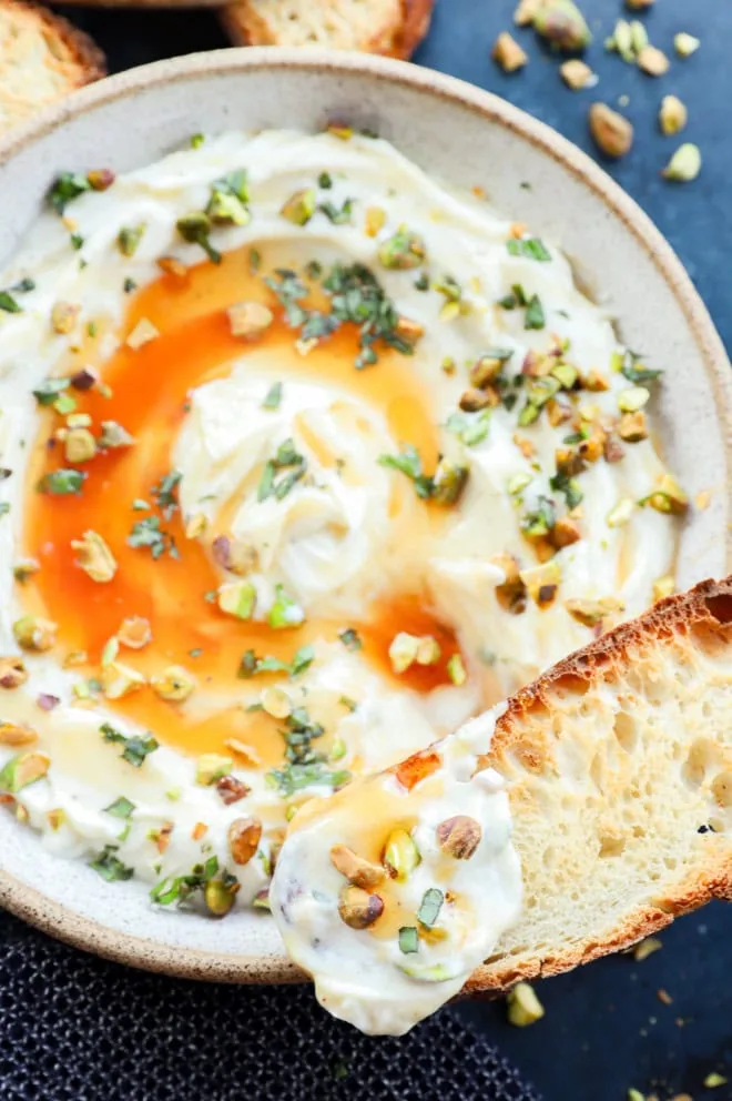 Toasted slices of bread with whipped ricotta and nuts
