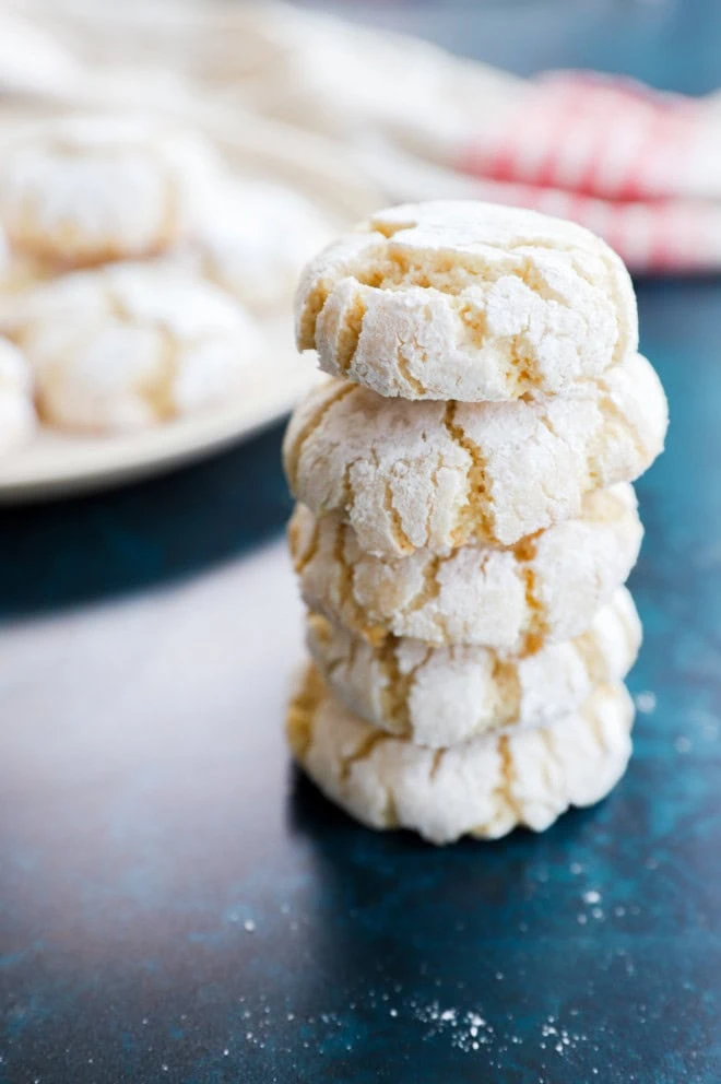 stack of amaretti cookies with more cookies on a plate in background