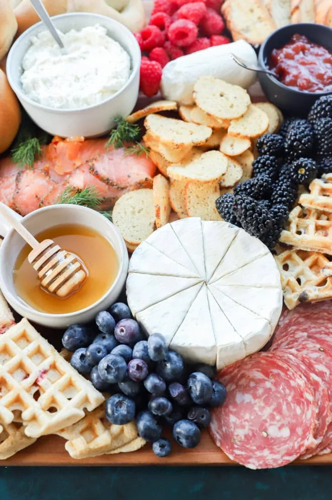 Waffle board image with waffles, fruit, meats, cheeses, and more