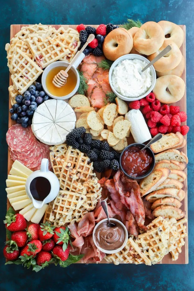 easy breakfast charcuterie board with fresh fruit, meats, cheeses, waffles, and more